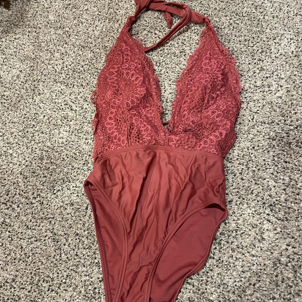 One piece swimsuit with lacy design top